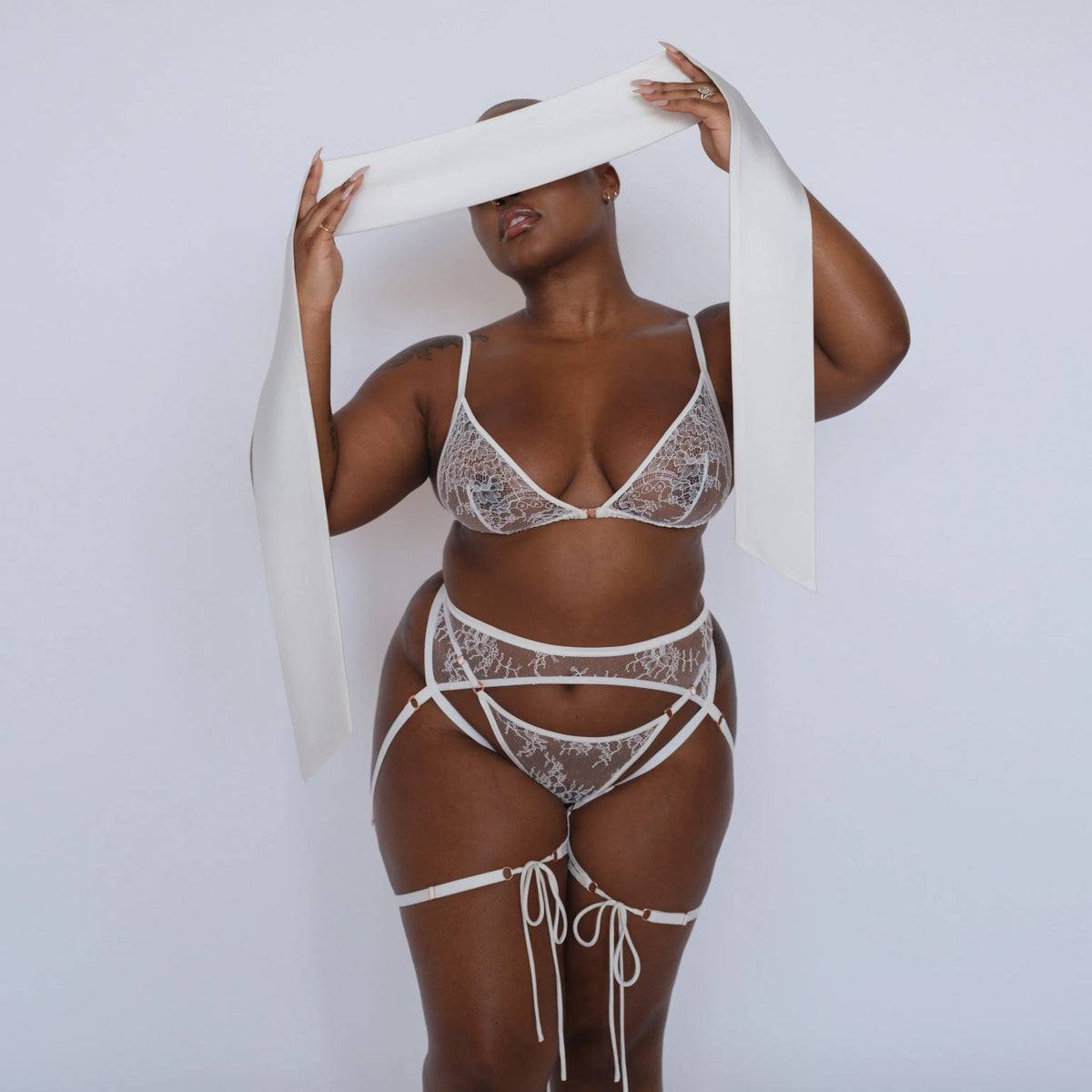 White ultra-fine floral lace balconette bra with flexible underwire, back closure and adjustable straps with matching bikini with corset-style lace up back and lace harness