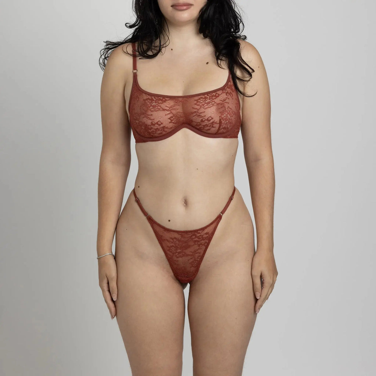 Brown stretch lace thong with a low rise and adjustable waist elastics and matching wired bralette with back closure