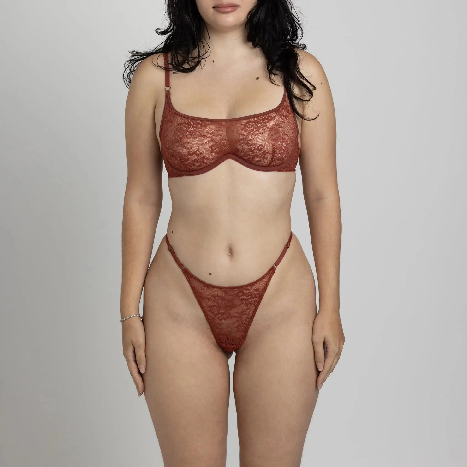 Brown stretch lace thong with a low rise and adjustable waist elastics and matching wired bralette with back closure