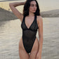 Black opaque on sheer striped microfiber bodysuit with plunge neckline fully adjustable straps criss crossed in back with snap close gusset