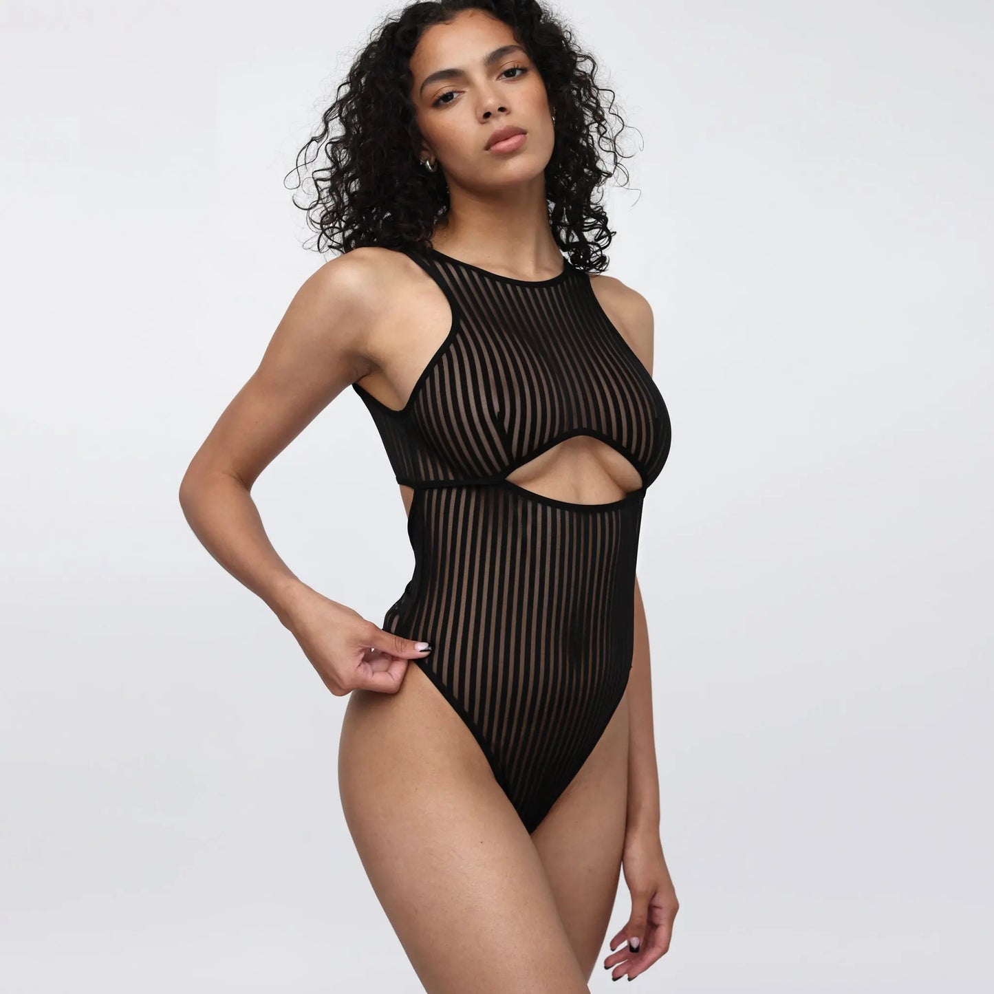 Black opaque on sheer striped microfiber bodysuit with back and front cutouts, snap closure at gusset and back clasp