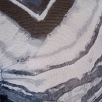 A close-up of a fabric pattern featuring abstract, organic wavy bands in shades of blues, white, and pale grey.