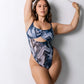 Blue abstract print mesh bodysuit with underwire and back closure, thong back coverage and button snap closure in gusset