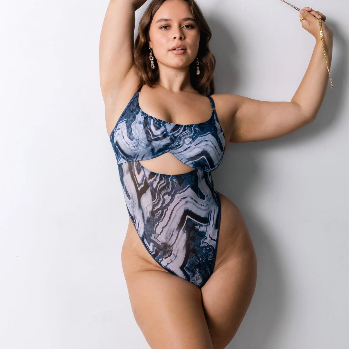 Blue abstract print mesh bodysuit with underwire and back closure, thong back coverage and button snap closure in gusset