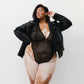 Black opaque on sheer striped microfiber bodysuit with plunge neckline fully adjustable straps criss crossed in back with snap close gusset
