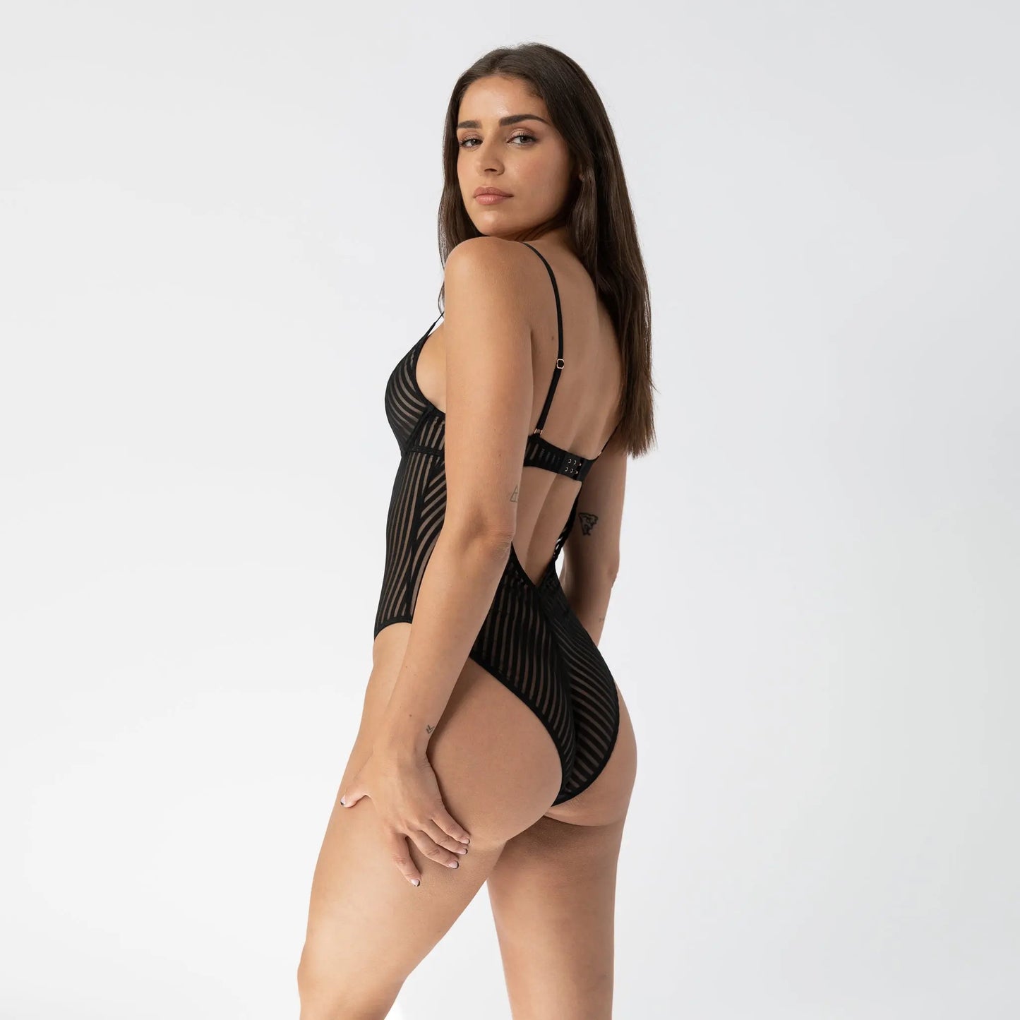 Black opaque on sheer striped microfiber bodysuit with flexible underwire, adjustable straps and back closure with button snap close at gusset
